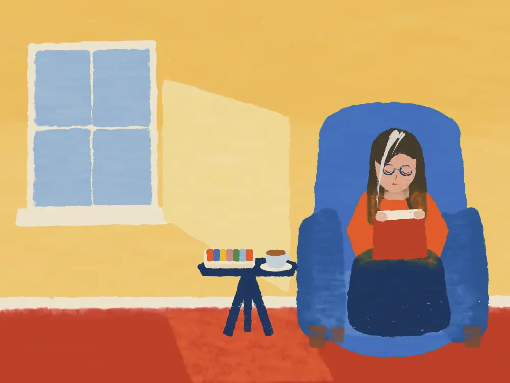 A woman curled in a blue armchair reading, a weekly pill box and a cup of tea beside her.